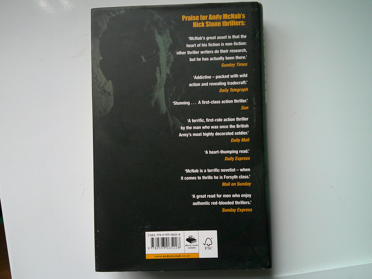 Back cover of a used Andy McNab thriller featuring praise and reviews of the book