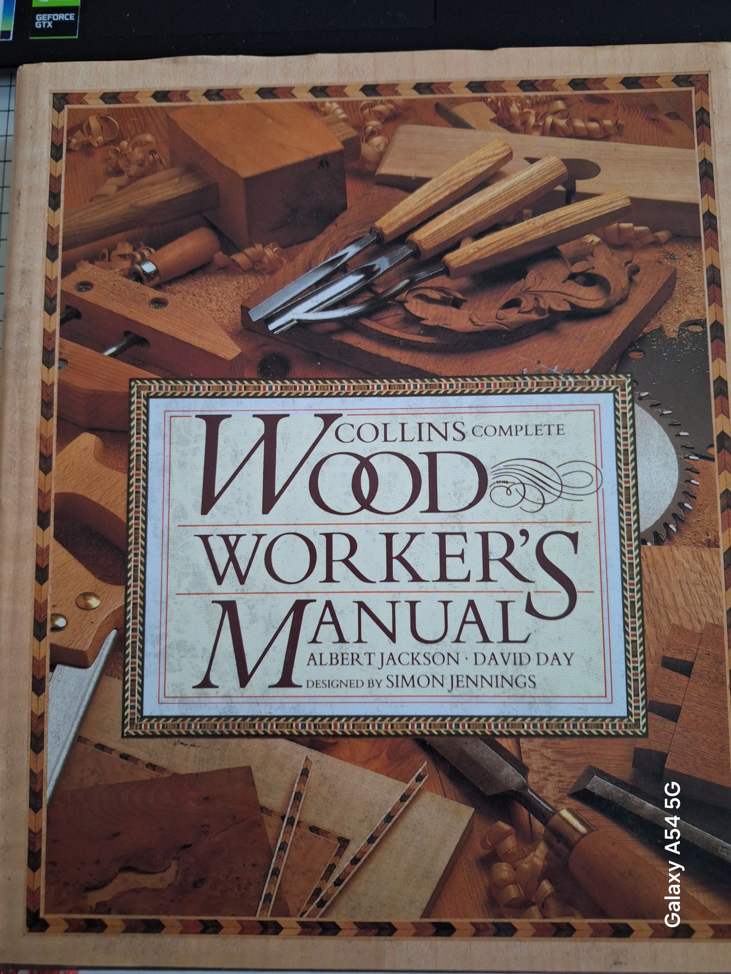Collins Complete Woodworker's Manual book among wood carving tools showcasing affordable craft and DIY guides