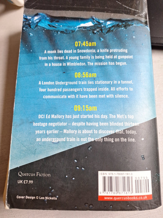 Back cover of Baptism Ed Mallory thriller book with synopsis and water splashes design