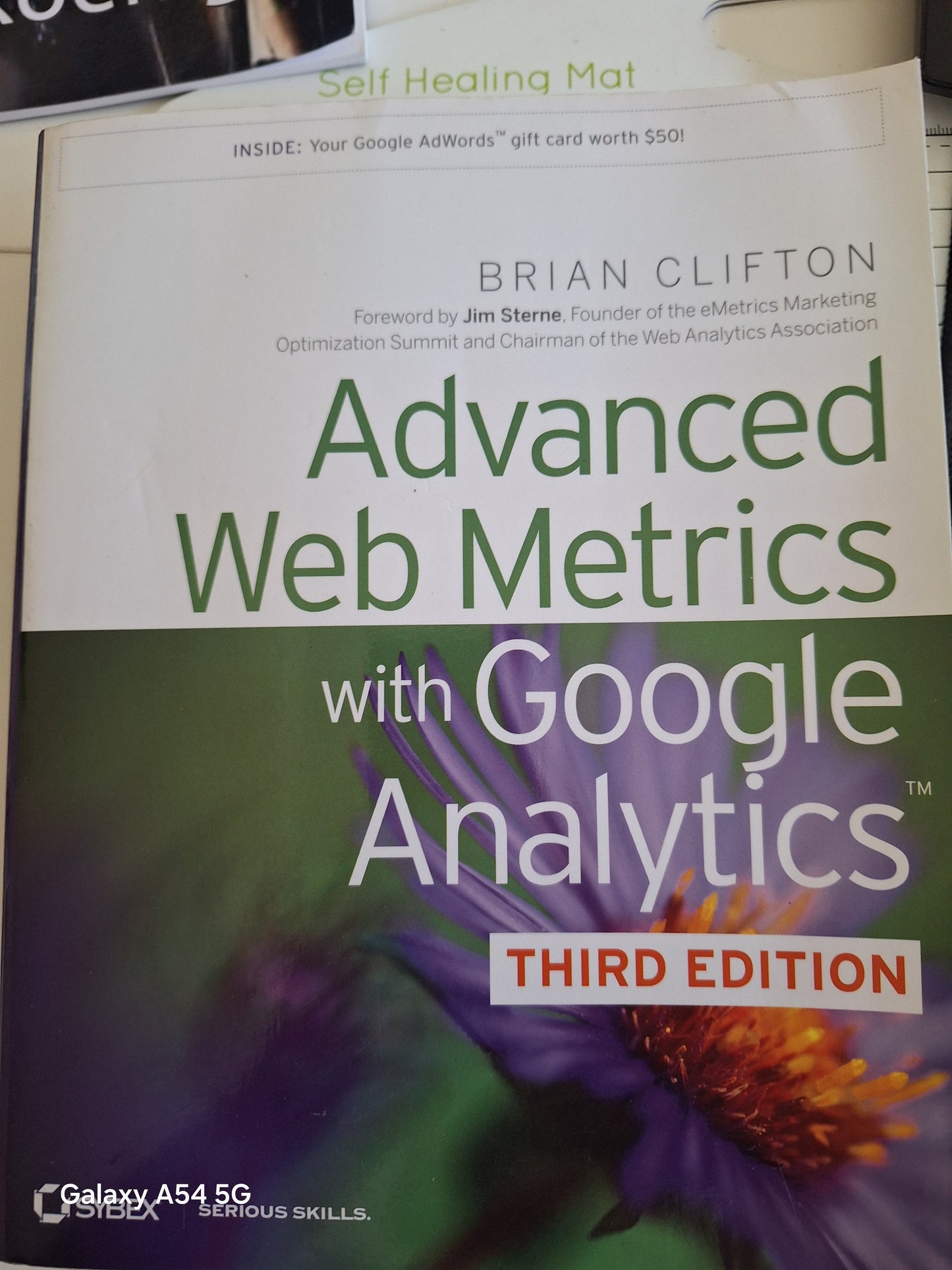 Advanced web metrics book by Brian Clifton with Google Analytics third edition cover showing purple flower