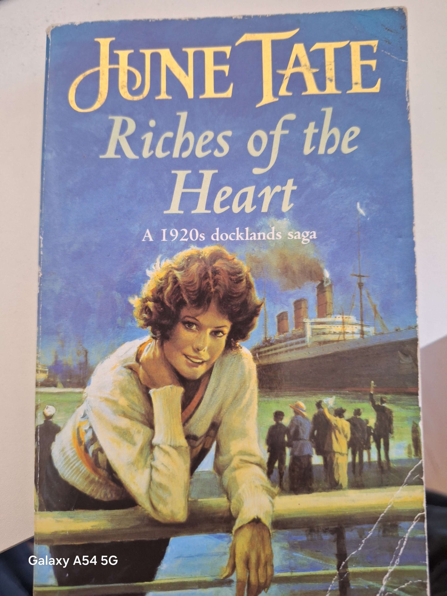 Riches of the Heart June Tate Book - 1920s Docklands Saga cover featuring a woman by the docks.