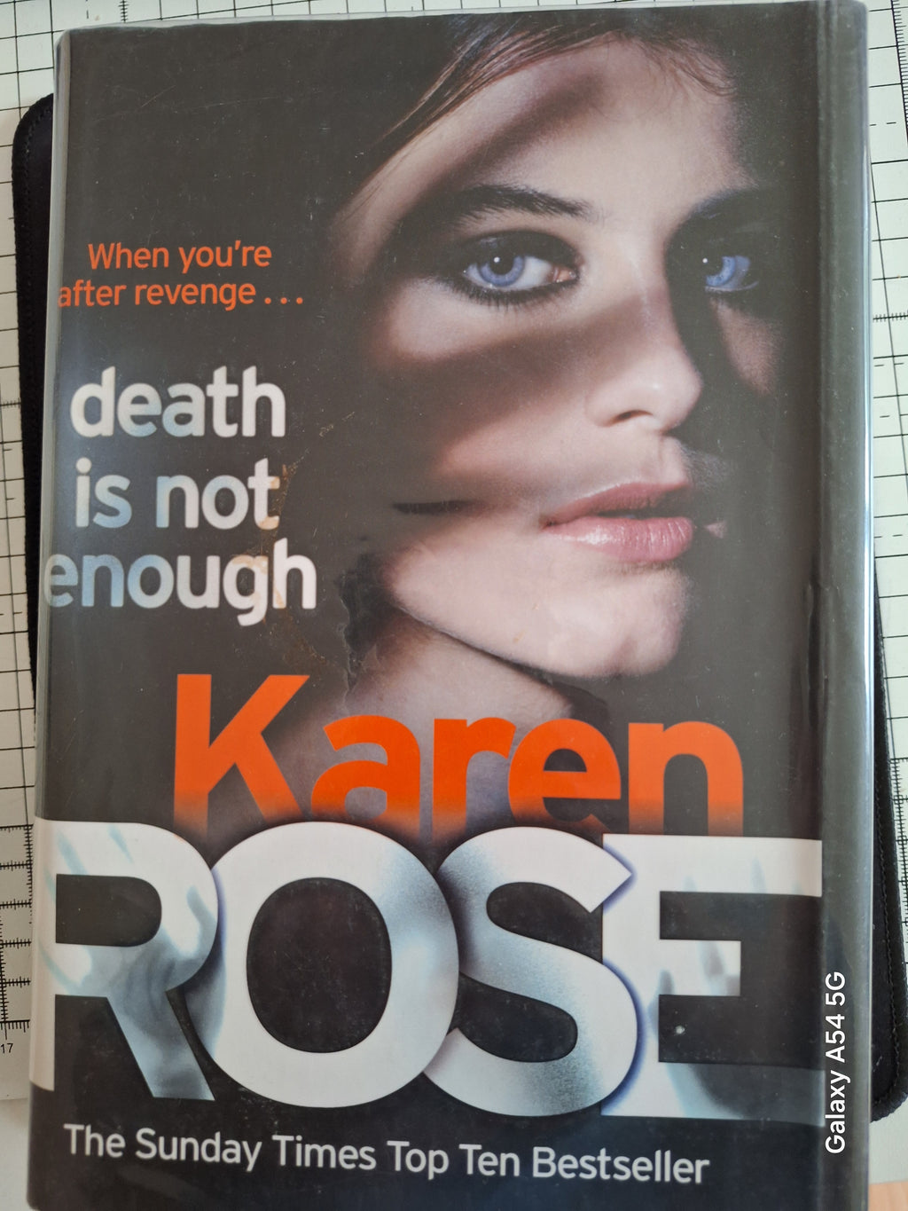 Hardcover book titled Death is not enough by Karen Rose featuring a close-up of a woman's face on the cover