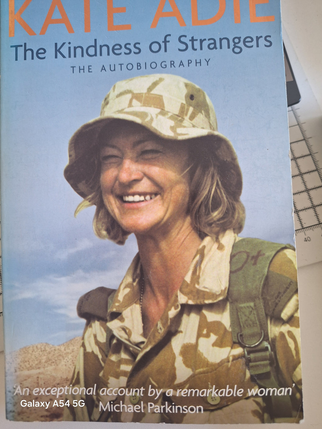 Cover of Kate Adie autobiography titled The Kindness of Strangers featuring Kate Adie in military attire