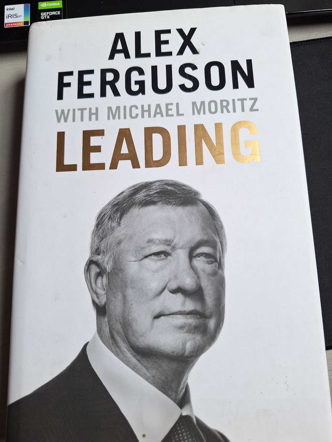 Leading book by Alex Ferguson with Michael Moritz featuring black and white portrait on the cover