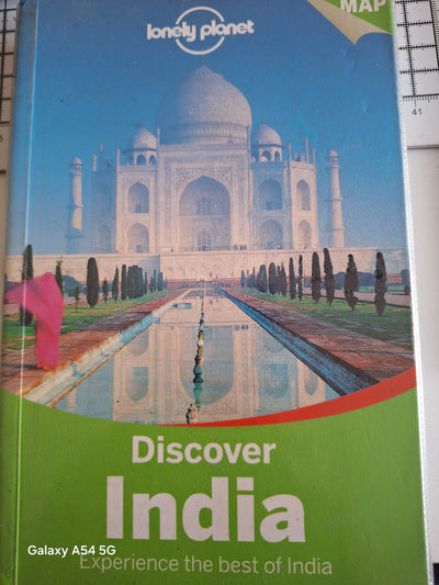 Lonely Planet Discover India guidebook featuring the Taj Mahal on the cover with vibrant colours