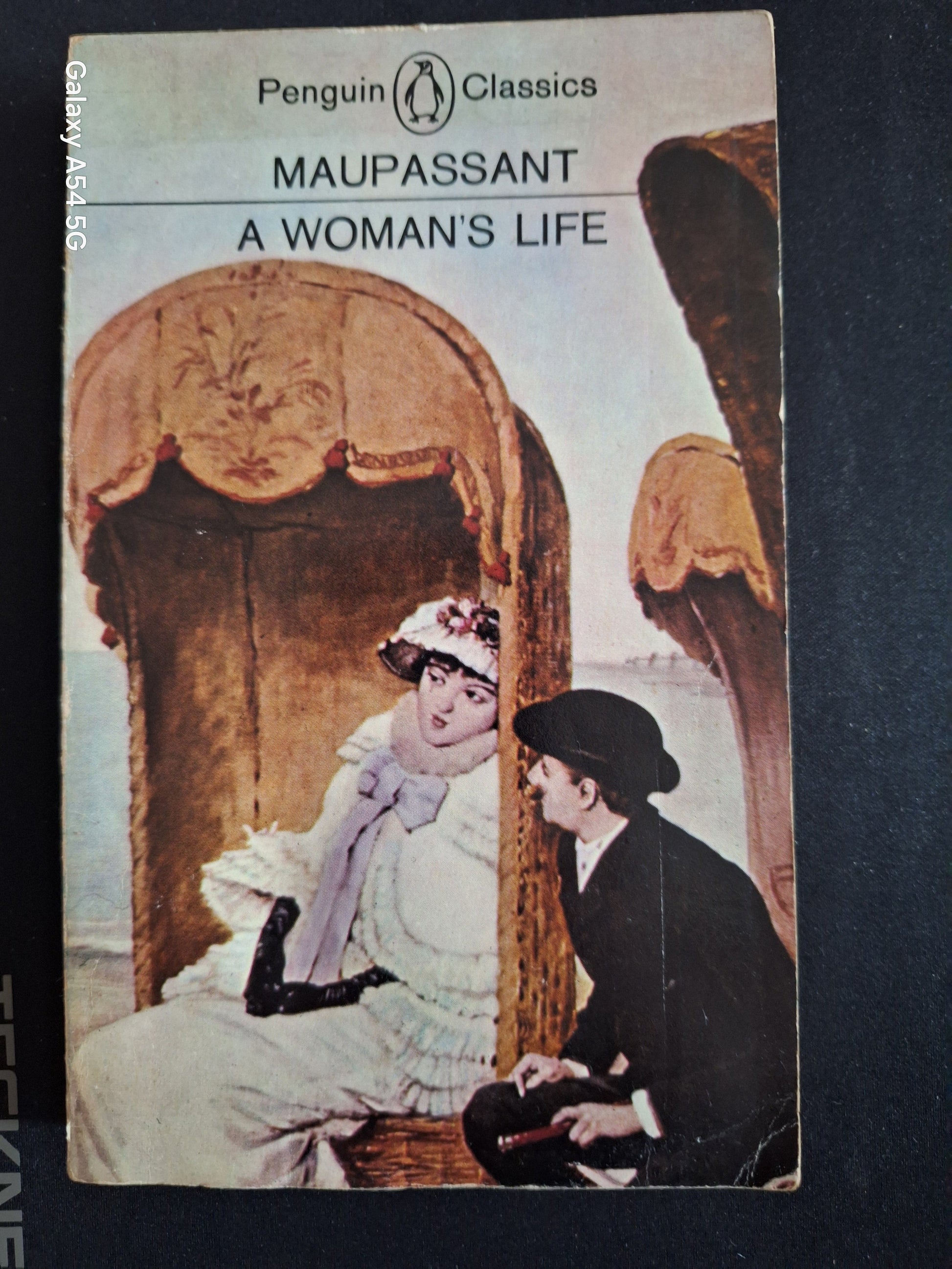 Penguin Classics Maupassant book A Woman's Life cover featuring vintage illustration of a woman and a man sitting