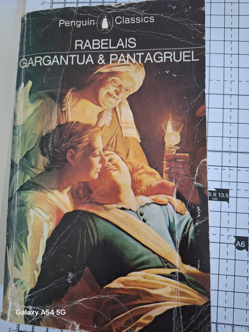 Worn Penguin Classics book cover of Gargantua and Pantagruel by Rabelais with classical painting artwork