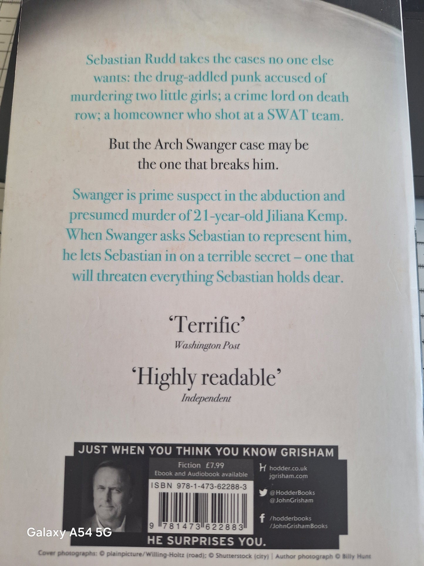 Back cover of a second hand John Grisham novel featuring a gripping synopsis and reviews