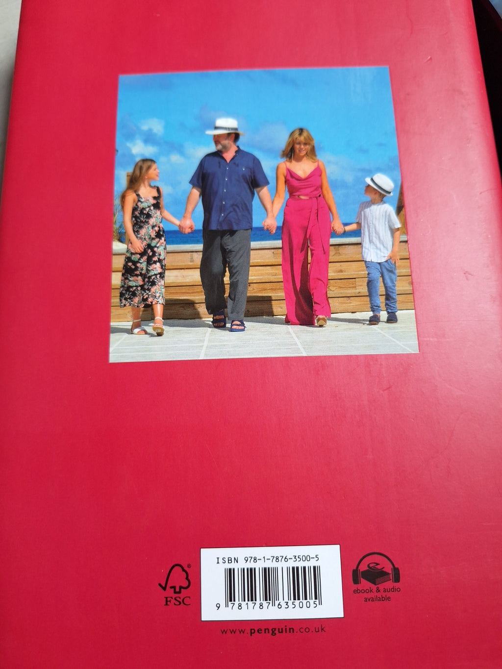 The power of hope book back cover showing family holding hands under blue sky on red background