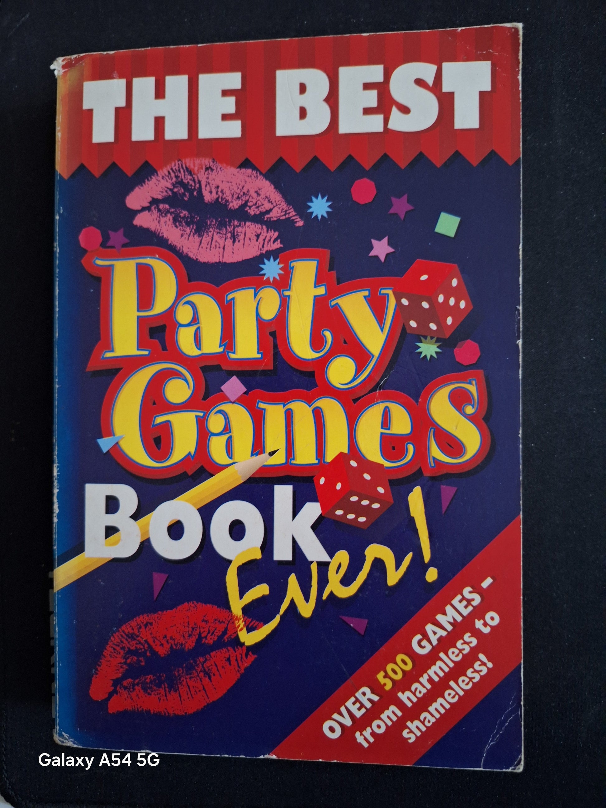 Used party games book titled The Best Party Games Book Ever with colourful cover featuring dice and lips