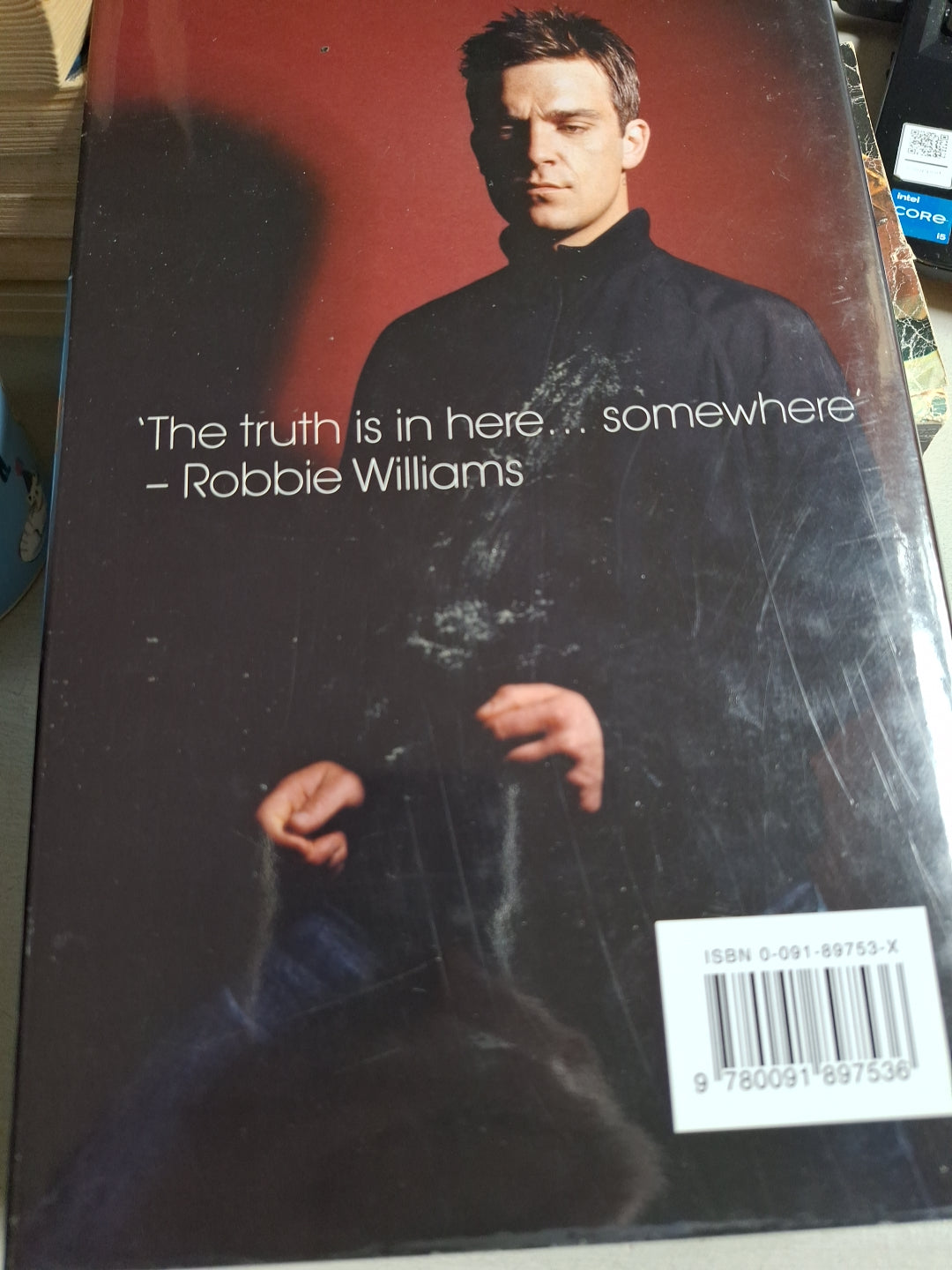Used Robbie Williams biography book with cover photo of Robbie Williams and quote on front
