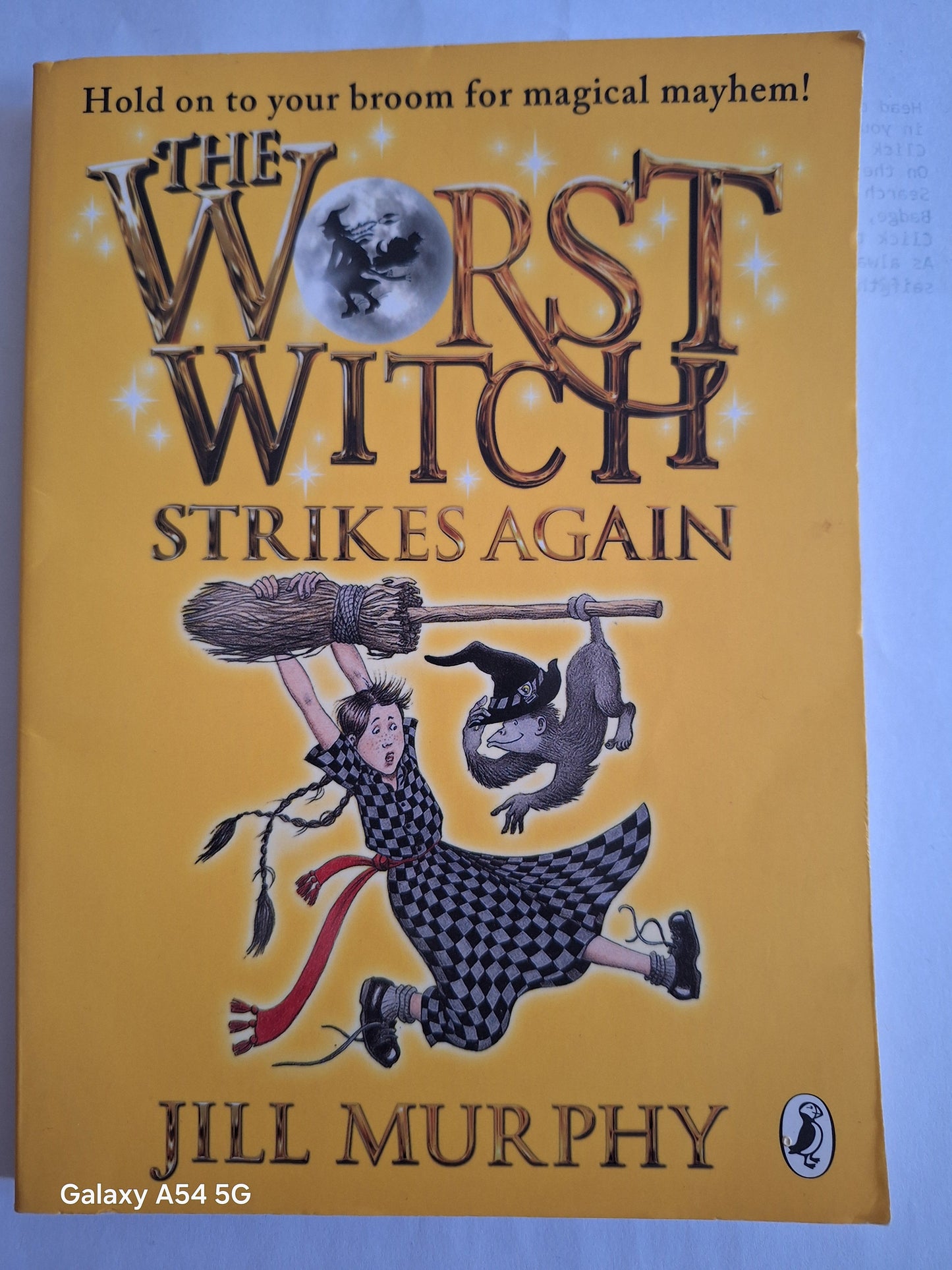 The Worst Witch Strikes Again used book by Jill Murphy featuring a witch with a broom and a cat