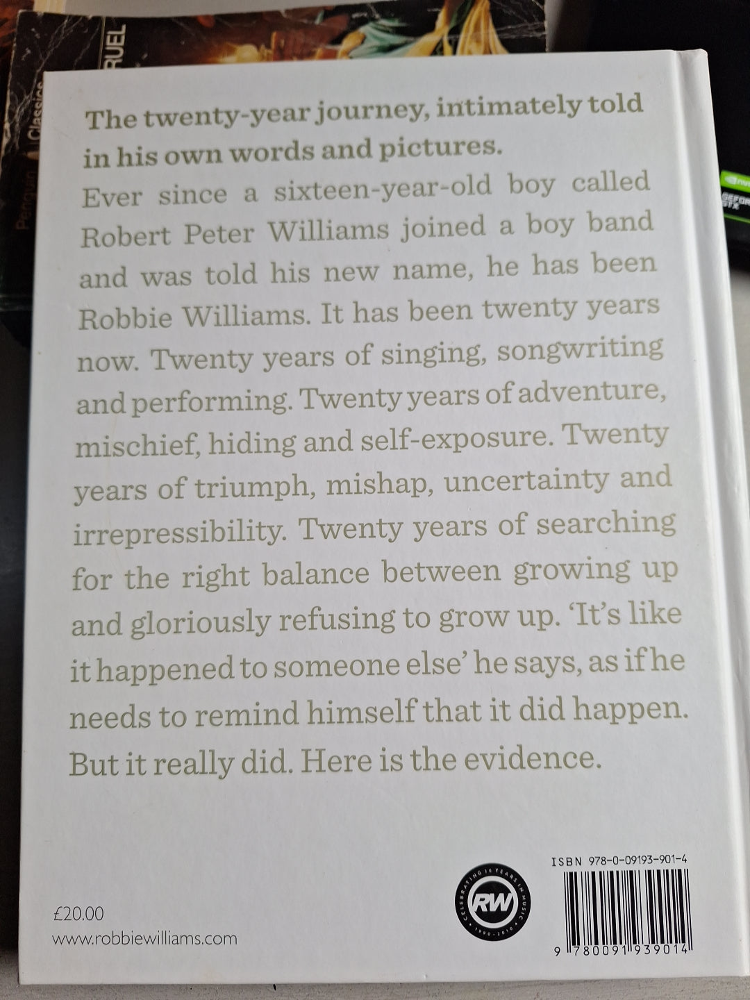 Back cover of the book You know me showing a summary of twenty years journey of Robbie Williams